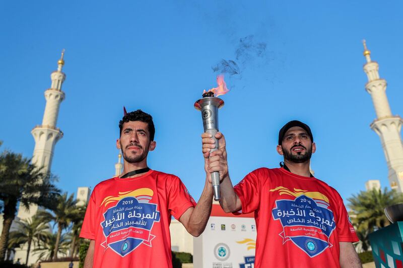 Abu Dhabi, UAE.  March, 14, 2018.  Law Enforcement Torch Run, Final Leg for Special Olympics.   Khalif Al Neimi and Sultan Al Khyeli proudly holds up the torch infront of the Abu Dhabi Grand Mosque.
Victor Besa / The National