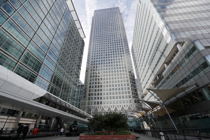FILE - In this July 28, 2017 file photo, is One Canada Square house, center, that hosts the offices of the European Banking Authority EBA, headquarters in London. Brexit is still well over year away but two cities on Monday, Nov. 20, 2017 will already be celebrating Britain's departure from the European Union. Two major EU agencies currently in London will be given a new home to move to and the two prizes are hotly fought over by most of the other 27 nations. (AP Photo/Frank Augstein, File)