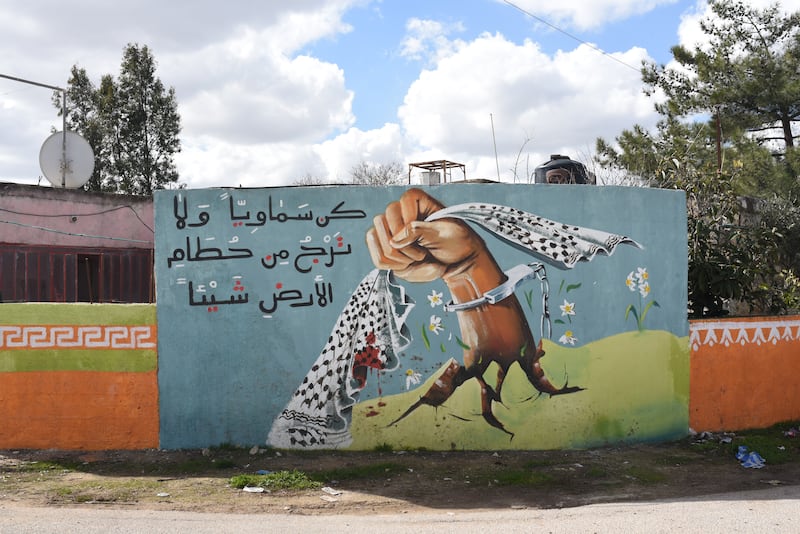 A mural telling people to stay hopeful despite the destruction of the land, in Beitin village, West Bank. 