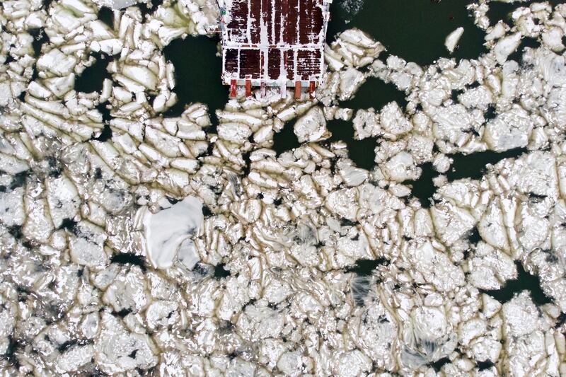 A photo taken with a drone shows a pier on the river Tisza covered by floating ice in Tiszacsege, Hungary.   EPA