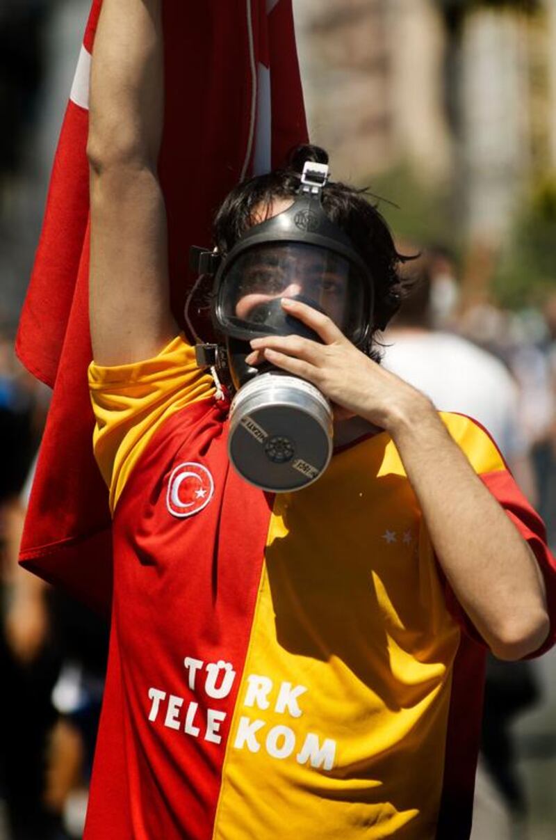 A Galatasary football fan in Taksim Square in June, when tear gas was used to quell demonstrations. Supporters from rival teams have come together since for anti-government protests. John Wreford for The National

