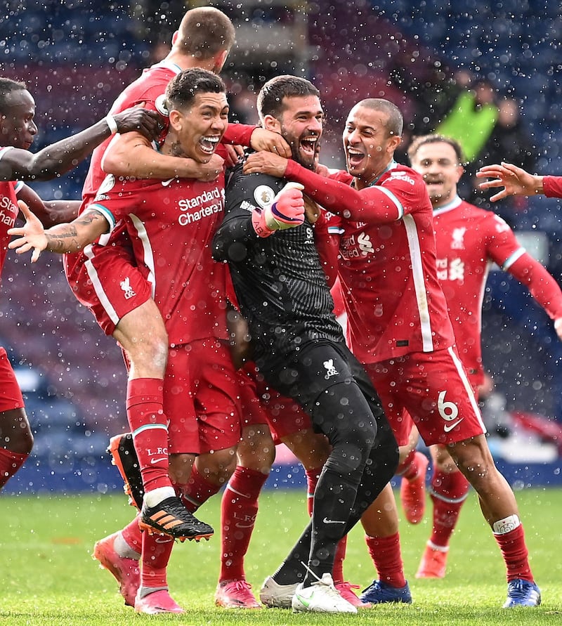 Liverpool's Brazilian goalkeeper Alisson Becker celebrates scoring his team's second goal with his teammates during the English Premier League football match between West Bromwich Albion and Liverpool at The Hawthorns stadium in West Bromwich, central England, on May 16, 2021.  - RESTRICTED TO EDITORIAL USE. No use with unauthorized audio, video, data, fixture lists, club/league logos or 'live' services. Online in-match use limited to 120 images. An additional 40 images may be used in extra time. No video emulation. Social media in-match use limited to 120 images. An additional 40 images may be used in extra time. No use in betting publications, games or single club/league/player publications.
 / AFP / POOL / Laurence Griffiths / RESTRICTED TO EDITORIAL USE. No use with unauthorized audio, video, data, fixture lists, club/league logos or 'live' services. Online in-match use limited to 120 images. An additional 40 images may be used in extra time. No video emulation. Social media in-match use limited to 120 images. An additional 40 images may be used in extra time. No use in betting publications, games or single club/league/player publications.
