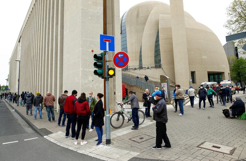 People queue outside the Central Mosque in Ehrenfeld suburb, as they wait for a COVID-19 vaccination, amid the coronavirus disease pandemic, in Cologne, Germany, May 8, 2021. REUTERS/Thilo Schmuelgen