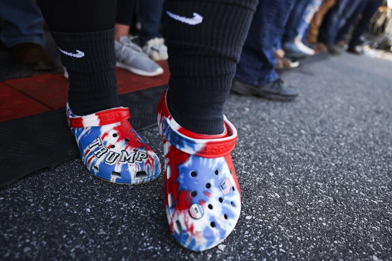 Kyndel Crouch wears Trump crocs as she waits to listen to President Donald Trump speak at a rally at the Hickory Regional Airport in Hickory, North Carolina. AFP