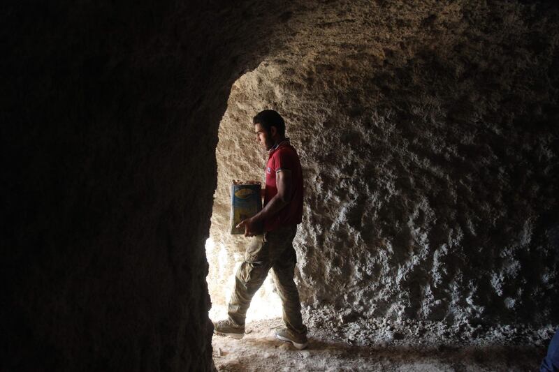 A Syrian digs a cave in the southern countryside of Idlib province in anticipation for an upcoming offensive. Amer Alhamwe/AFP