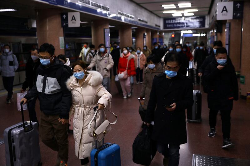 Travellers walk through a railway station in Beijing. Reuters