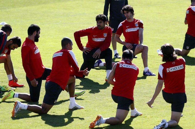 Atletico Madrid players stretch before their training session on Friday ahead of Saturday's match with Barcelona. Javier Lizon / EPA / May 16, 2014