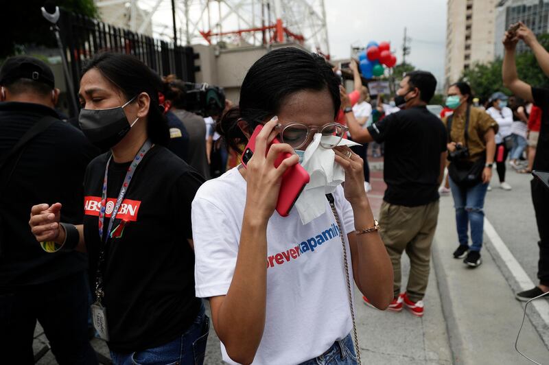 A supporter wipes her tears after hearing the results of the voting in the House of Representatives on the franchise renewal of ABS-CBN at the company headquarters in Quezon City. AP Photo