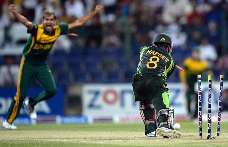 Pakistan's batsman Mohammad Hafeez, right, is clean bowled by South African bowler Imran Tahir during the fourth day-night international at Sheikh Zayed Cricket Stadium in Abu Dhabi Friday. South Africa leads the five-match series 3-1. Asif Hassan / AFP

