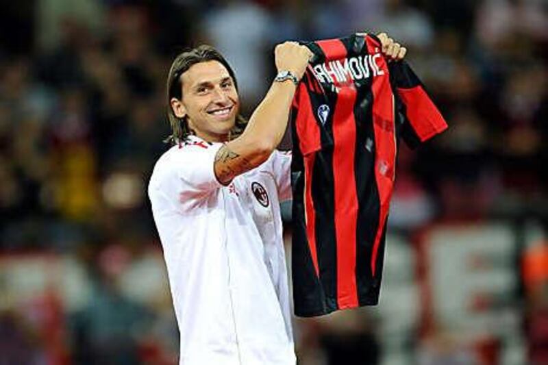 Zlatan Ibrahimovic poses with an AC Milan shirt on Sunday night before the team's game with Lecce.