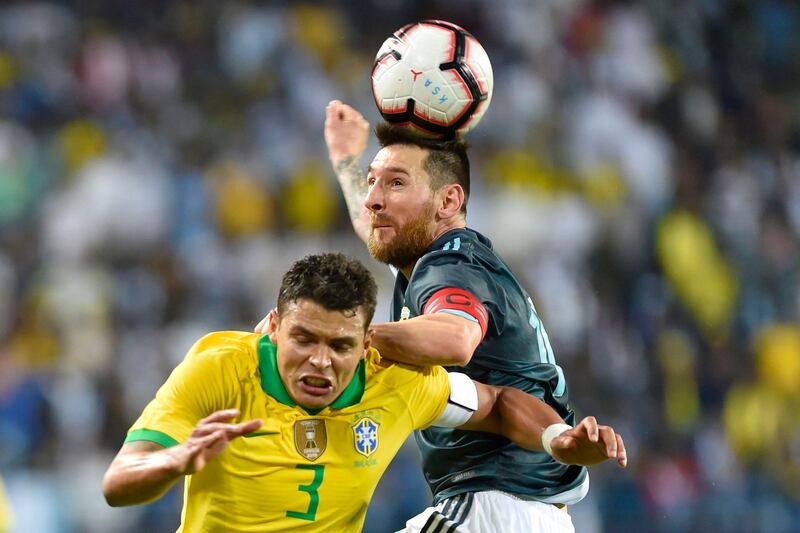 Messi, right, heads the ball past Brazil's Thiago Silva during the match between Brazil and Argentina at King Fahd stadium in Riyadh, Saudi Arabia. AP