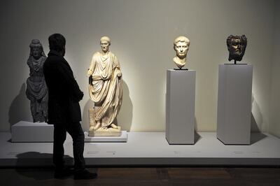 A statue of Bodhisattva, a statue of a Roman speaker, a head of Auguste (adopted son of Jules Cesar) and are seen on display at the Louvre Museum in Paris during an exhibition about the launch of the Louvre Abu Dhabi collection.
Picture: Antoine Antoniol for The National