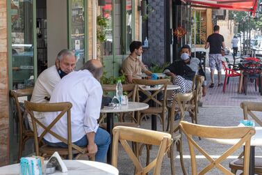 People sit at an Amman restaurant that reopened to the public on June 6 as Jordan lifted strict coronavirus restrictions after more than two months. Jordan raised $1.75 billion through a double tranche eurobond. EPA