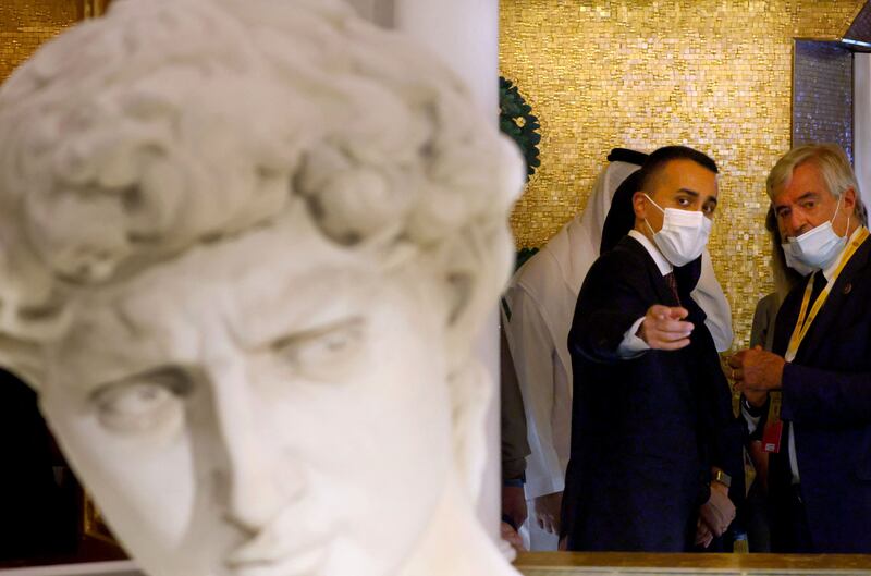 Italian Foreign Minister Luigi Di Maio makes a point about the 3D printed replica of Michelangelo’s David statue at the Italian Expo pavilion. AFP