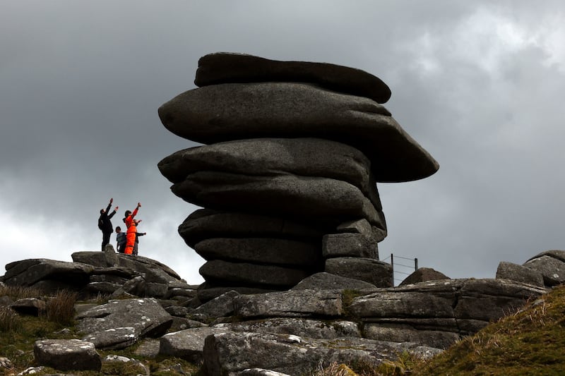 People climb up to a natural structure known as The Cheesewring on Bodmin Moor, in Cornwall, Britain. Reuters