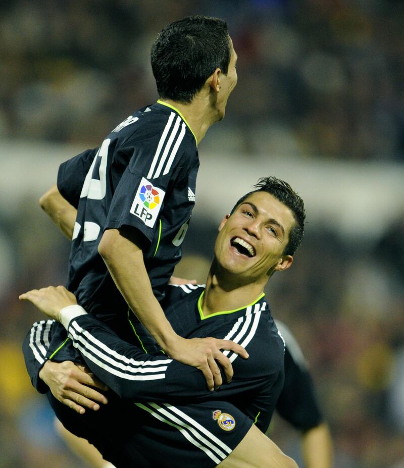 Real Madrid's Argentinian midfielder Angel di Maria (L) and Real Madrid's Portuguese forward Cristiano Ronaldo (R) celebrate after scoring their third goal during the Spanish League football match Zaragoza against Real Madrid at the La Romareda stadium in Zaragoza, on December 12, 2010. AFP PHOTO/JAVIER SORIANO (Photo by JAVIER SORIANO / AFP)