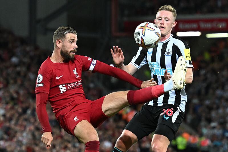 Liverpool's Jordan Henderson battles for the ball with Sean Longstaff of Newcastle. AFP