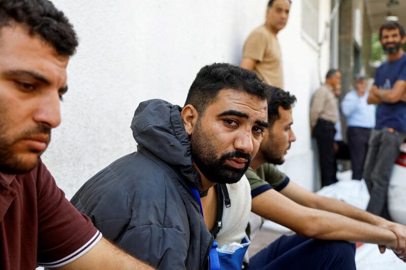 A wounded Palestinian man Ala Al-Kafarneh, who survived Israeli strikes, attends a hospital in Gaza city.  Mr Al-Kafarneh lost his pregnant wife and several members of his family in air strikes after they fled Beit Hanoun. Reuters