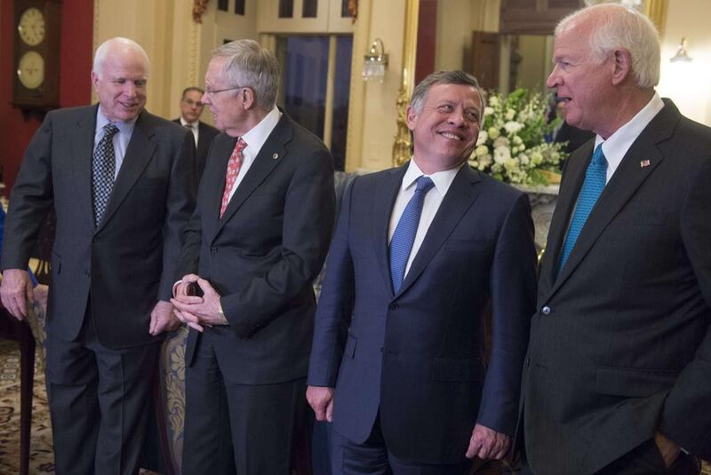 King Abdullah II of Jordan, second from right, with US senator Saxby Chambliss, right, Senate majority leader Harry Reid, second from left,  and senator John McCain at the US Capitol in Washington, DC, on December 2, 2014. Saul Loeb / AFP