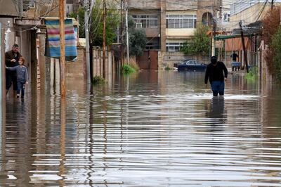 epa08304668 An Iraqi man walks amid a flooded street in Mosul, northern Iraq, 18 March 2020.  According to media reports, heavy overnight rainfall in the northern Iraqi province of Nineveh disrupted daily activity, as floods tore through parts of the city's already dilapidated infrastructure.  EPA/AMMAR SALIH