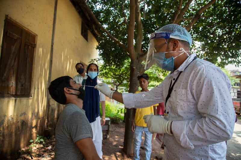 A health worker takes a swab sample from a man to test for Covid-19 in Guwahati, India. AP