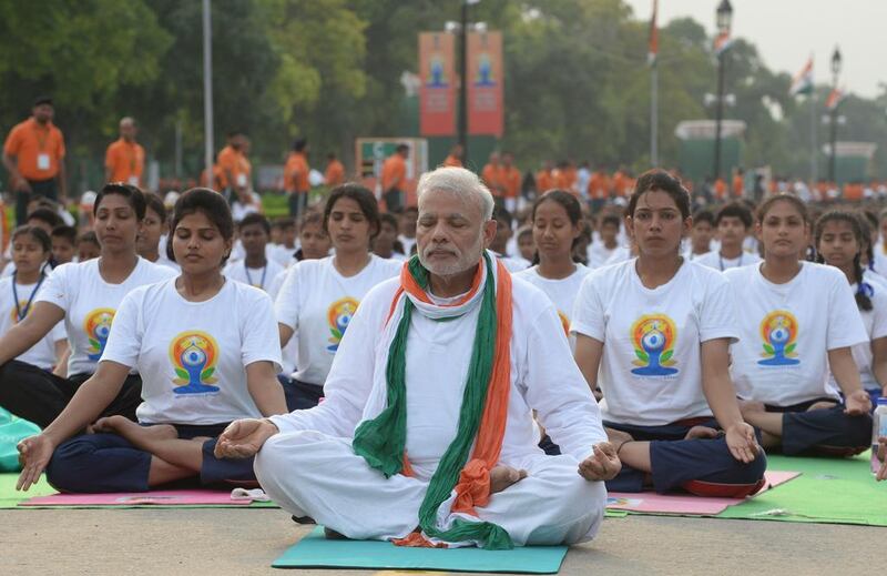 Indian prime minister Narendra Modi, centre, led a mass yoga session along with other Indian yoga practitioners to mark  International Yoga Day on Rajpath in New Delhi on June 21, 2015. Prakash Singh/AFP Photo