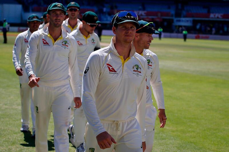 Australia's captain Steve Smith (C) leads his team including David Warner (R), off the field after their defeat on the fourth day of the second Test cricket match between South Africa and Australia at St George's Park in Port Elizabeth on March 12, 2018.
South Africa won by 6 wickets to level the four match Test series. / AFP PHOTO / MARCO LONGARI