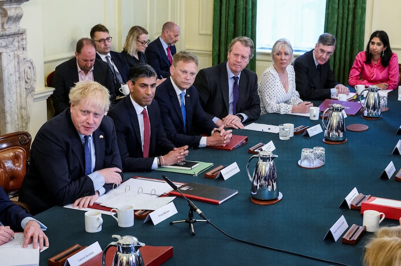 Ms Braverman, in pink, listens as former prime minister Boris Johnson addresses his Cabinet in Downing Street in June 2022. Reuters