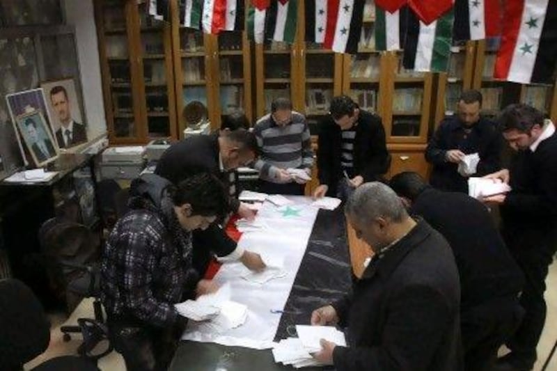 Syrian government workers count votes at the end of the referendum for a new constitution in Damascus. Syrians voted on a new constitution in the face of opposition calls for a boycott and further shellings in restive cities.