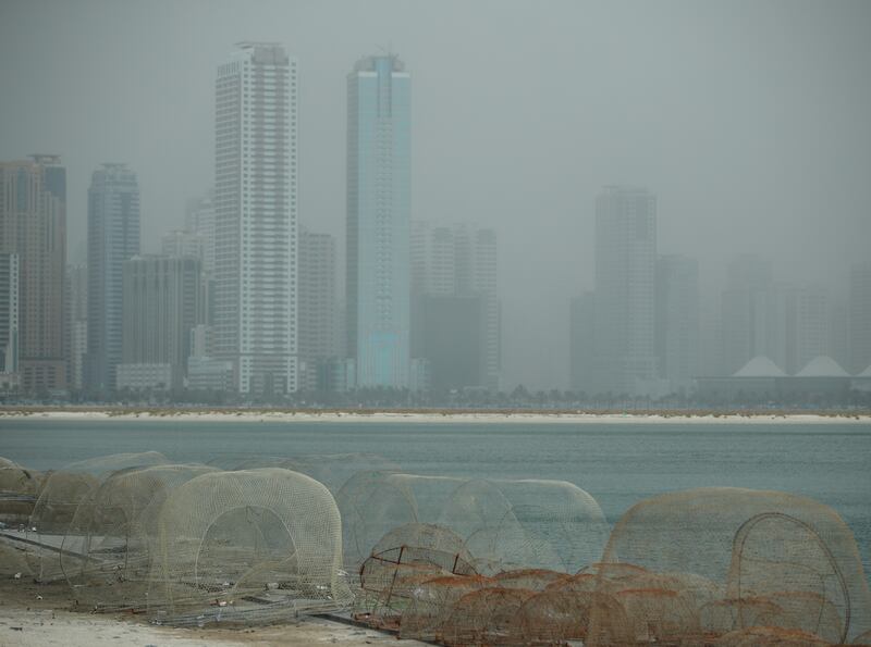 Hazy weather along the corniche in Sharjah. Victor Besa / The National
