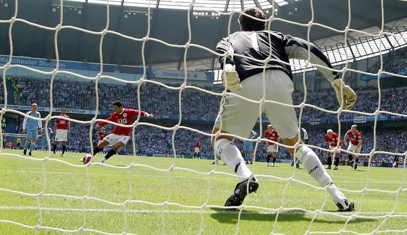 Manchester United's Cristiano Ronaldo (C) scores from the penalty spot past Manchester City's Andreas Isaksson during their English Premiership football  match at The City of Manchester Stadium, Manchester,  north-west England, 05 May 2007. AFP PHOTO/ANDREW YATES Mobile and website use of domestic English football pictures subject to subscription of a license with Football Association Premier League (FAPL) tel : +44 207 298 1656. For newspapers where the football content of the printed and electronic versions are identical, no licence is necessary. (Photo by ANDREW YATES / AFP)