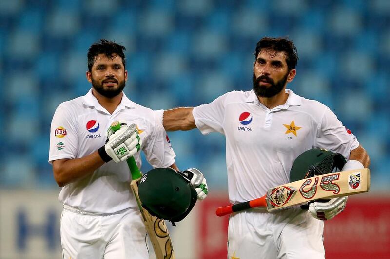 DUBAI, UNITED ARAB EMIRATES - OCTOBER 14:  Azhar Ali  is congratulated by  Misbah-ul-Haq  on scoring a triple century during Day Two of the First Test between Pakistan and West Indies at Dubai International Cricket Ground on October 14, 2016 in Dubai, United Arab Emirates.  (Photo by Francois Nel/Getty Images)