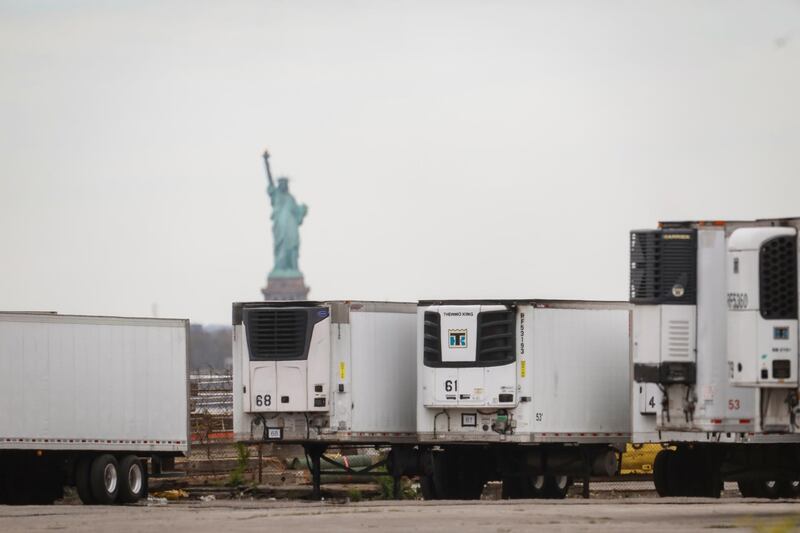 Refrigerated tractor trailers used to store bodies of deceased people are seen at a temporary morgue in the Brooklyn borough of New York City. Reuters