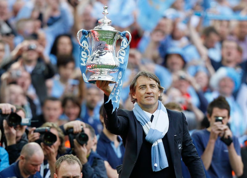 Manchester City's manager Roberto Mancini celebrates their win over Stoke City at the end of their English FA Cup Final soccer match at Wembley Stadium, London, Saturday, May 14, 2011. (AP Photo/Kirsty Wigglesworth) *** Local Caption ***  LST157_Britain_Soccer_FA_Cup_Final.jpg