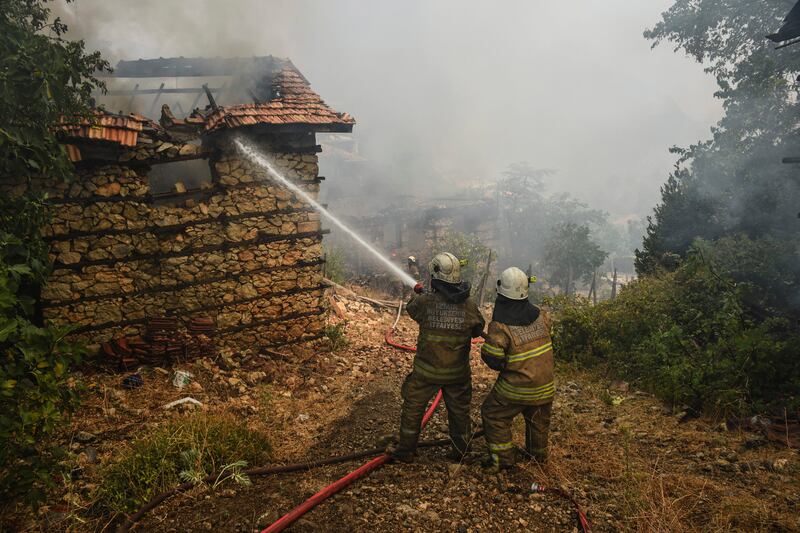 Firefighters tackle a burning building in Sirtkoy.