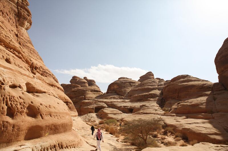 Visitors walk through the ancient rock heritage site at Al Ula, Saudi Arabia. Saudi Arabia's Crown Prince Mohammed Bin Salman officially launched his vision of the mega tourism project at the ancient site of Al Ula. Bloomberg