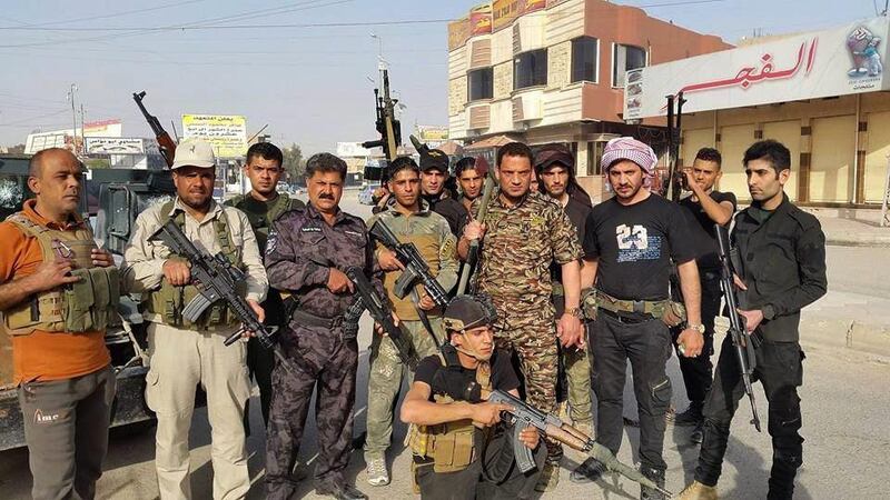 Iraqi security forces and tribal fighters pose for a photograph in central Ramadi, 115 kilometres west of Baghdad, Iraq, on April 16, 2015. AP Photo