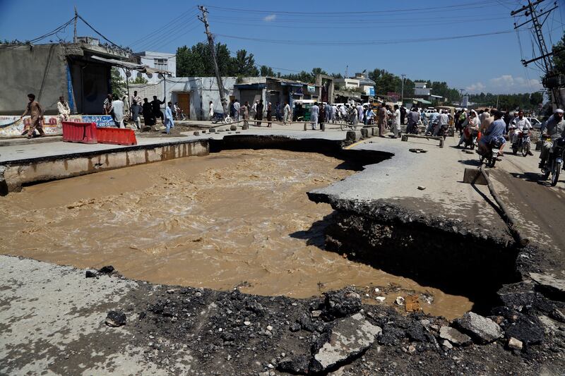 Flood damage to a road on the outskirts of Peshawar, Pakistan. AP