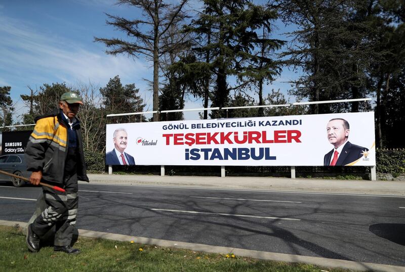 epa07478405 A man passes in front of a huge banner with pictures of Turkish President Recep Tayyip Erdogan and Binali Yildirim, candidate of Turkish ruling party Justice and Development Party (AK Party) reading 'Thank you Istanbul' in Istanbul, Turkey, 01 April 2019. According to reports, Supreme Election Board (YSK) chairman made a statement about Turkey's opposition candidate for Istanbul mayor Ekrem Imamoglu leading by nearly 28,000 votes after the local election. Some 57 milion people voted in local elections in Turkey's capital and the country's overall 81 provinces.  EPA/ERDEM SAHIN