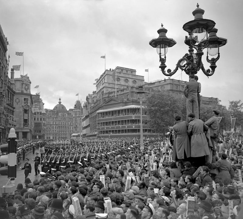 A crowded Trafalgar Square in the rain as troops march past on the return from Westminster Abbey after the coronation of Queen Elizabeth.