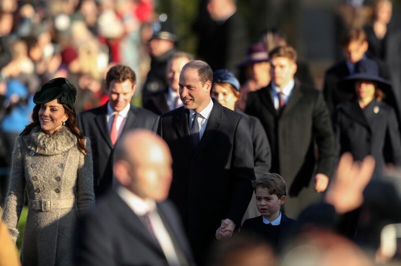 Britain's Prince William, centre and Kate, Duchess of Cambridge, left, arrive with their son Prince George, centre right, to attend the Christmas day service at St Mary Magdalene Church. AP