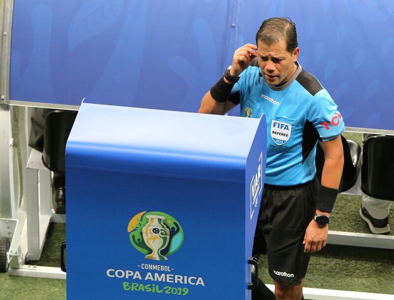 FILE PHOTO: Soccer Football - Copa America Brazil 2019 - Group B - Colombia v Paraguay - Arena Fonte Nova, Salvador, Brazil - June 23, 2019   Referee Victor Carrillo refers to the VAR screen pitchside before disallowing a goal for Colombia  REUTERS/Rodolfo Buhrer/File Photo
