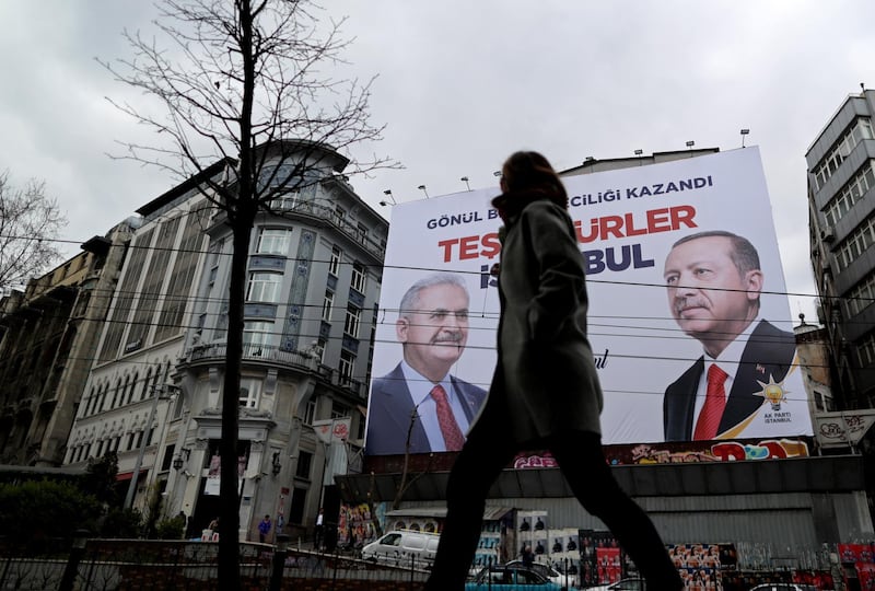 epa07479899 People pass in front of a huge banner with pictures of Turkish President Recep Tayyip Erdogan and Binali Yildirim, candidate of Turkish ruling party Justice and Development Party (AKP) reading 'Thank you Istanbul' in Istanbul, Turkey, 02 April 2019. According to preliminary results, CHP candidate for Istanbul mayor, Ekrem Imamoglu, beat the AKP candidate Binali Yildirim, by 25,000 votes in what was viewed as a blow to President Recep Tayyip Erdogan's grip on power, as the ruling party, an Islamist conservative outfit, also lost the capital, Ankara.  EPA/ERDEM SAHIN