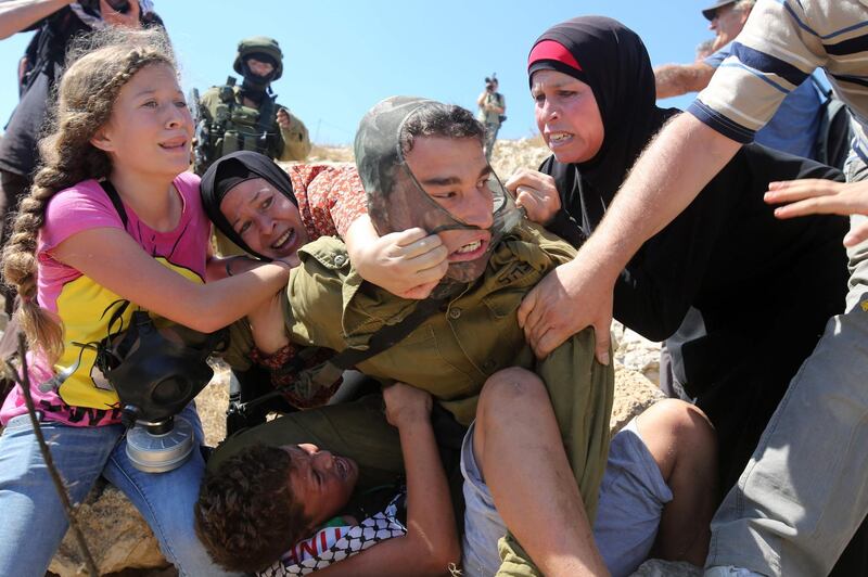 Taken in August 2015 Ahed fights with other members of her family to free her brother held by an Israeli soldier. AFP