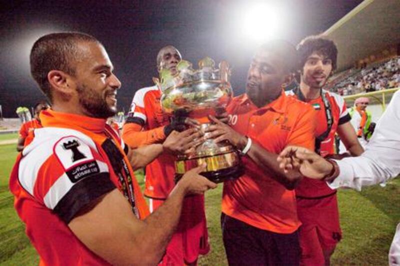Dubai, United Arab Emirates, May 14, 2013 -    Ajman players celebrate with the trophy after winning against Jazira during the Pro League Etisalat Cup final at Al Wasl's Zabeel Stadium. ( Jaime Puebla / The National Newspaper ) 
