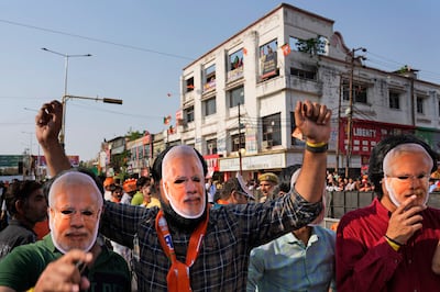 Supporters of the Bharatiya Janata Party wear Modi masks during an election campaign event in Ghaziabad. AP