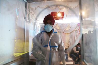 A health worker conducts a Covid-19 test at a test centre in Srinagar, the summer capital of Indian Kashmir. EPA