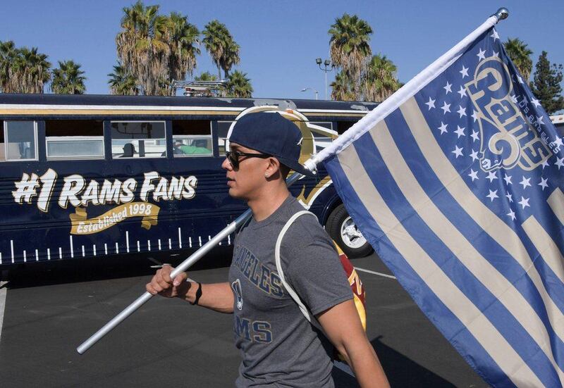 An LA Rams fan walks with a flag before Sunday's game. Kirby Lee / USA Today Sports