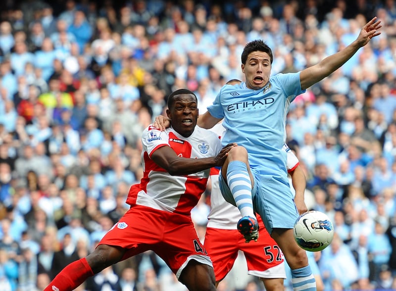 Queens Park Rangers' Nedum Onuoha vies with Manchester City's Samir Nasri. AFP