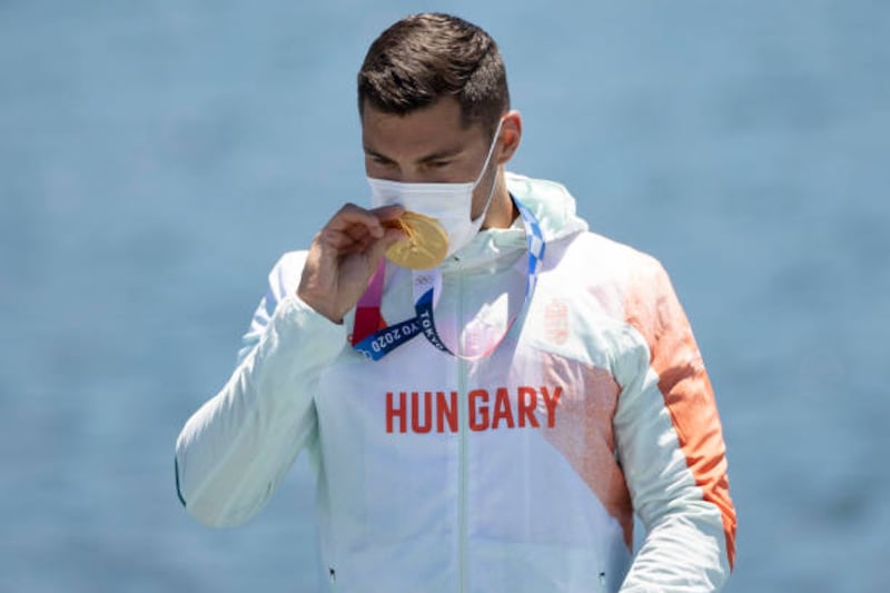 Gold medalist Sandor Totka of Team Hungary celebrates at the medal ceremony following the Men's Kayak Single 200m Final.